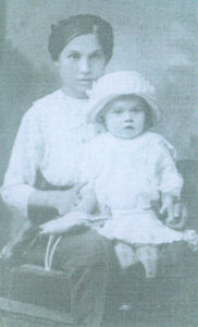 Elizabeth, daughter of Christophoris Schlacter, holding her younger sister in Yugoslavia, about 1917.
